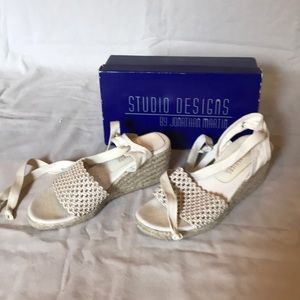 Cream colored wedge sandal with ankle ties.